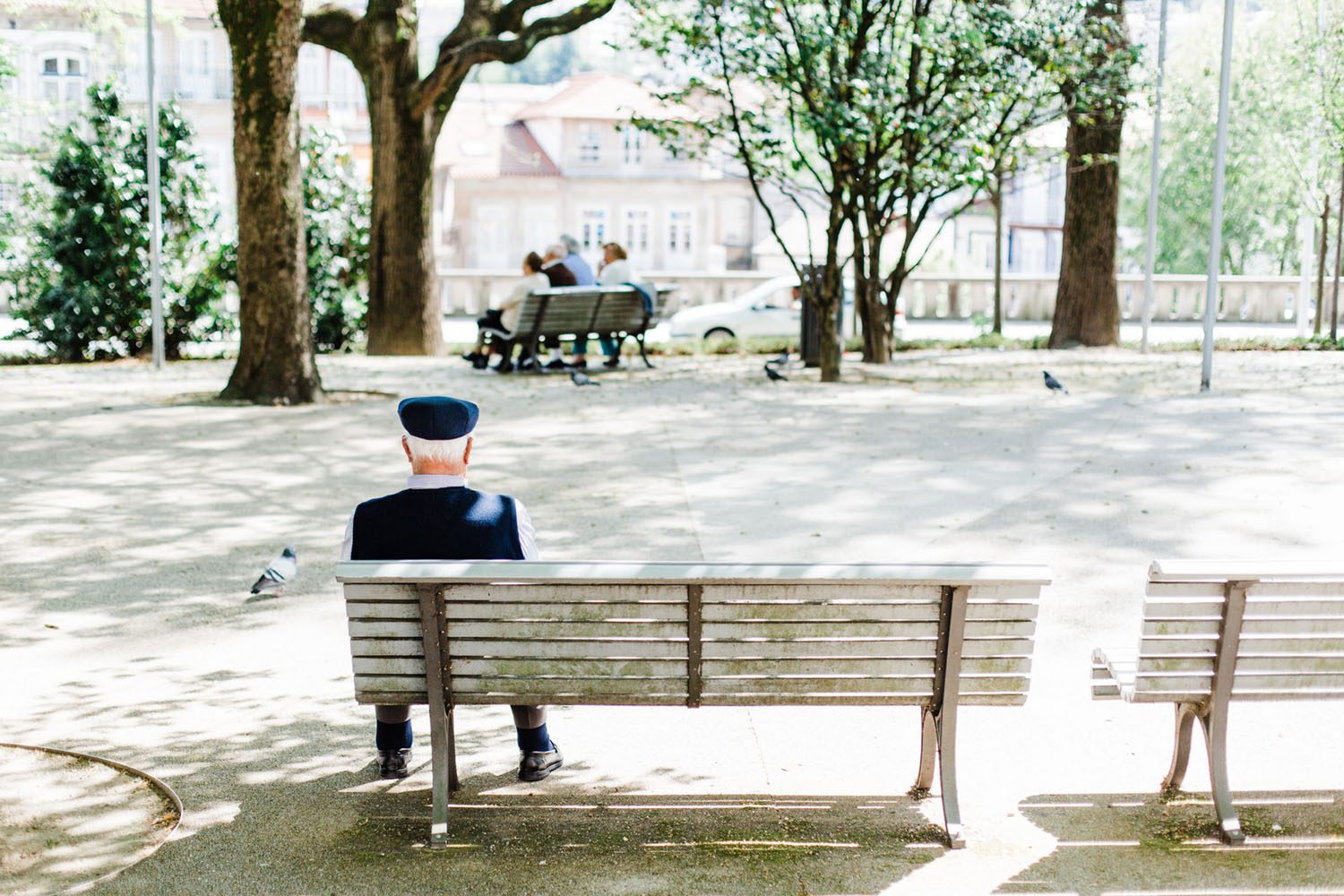 elderly man sitting on a park bench Alzheimer’s Disease