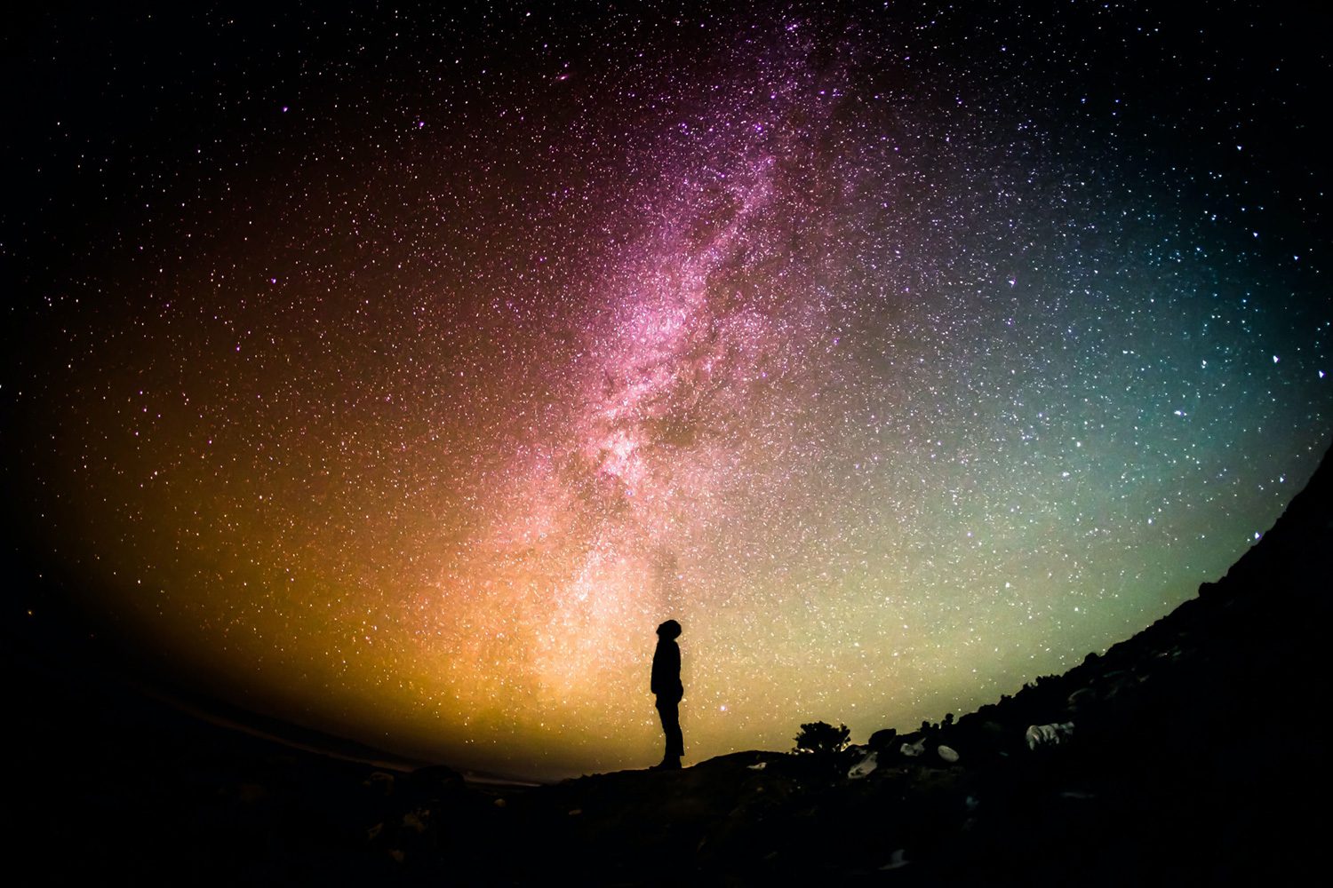 lone man looking up at the galaxy at night shared reality