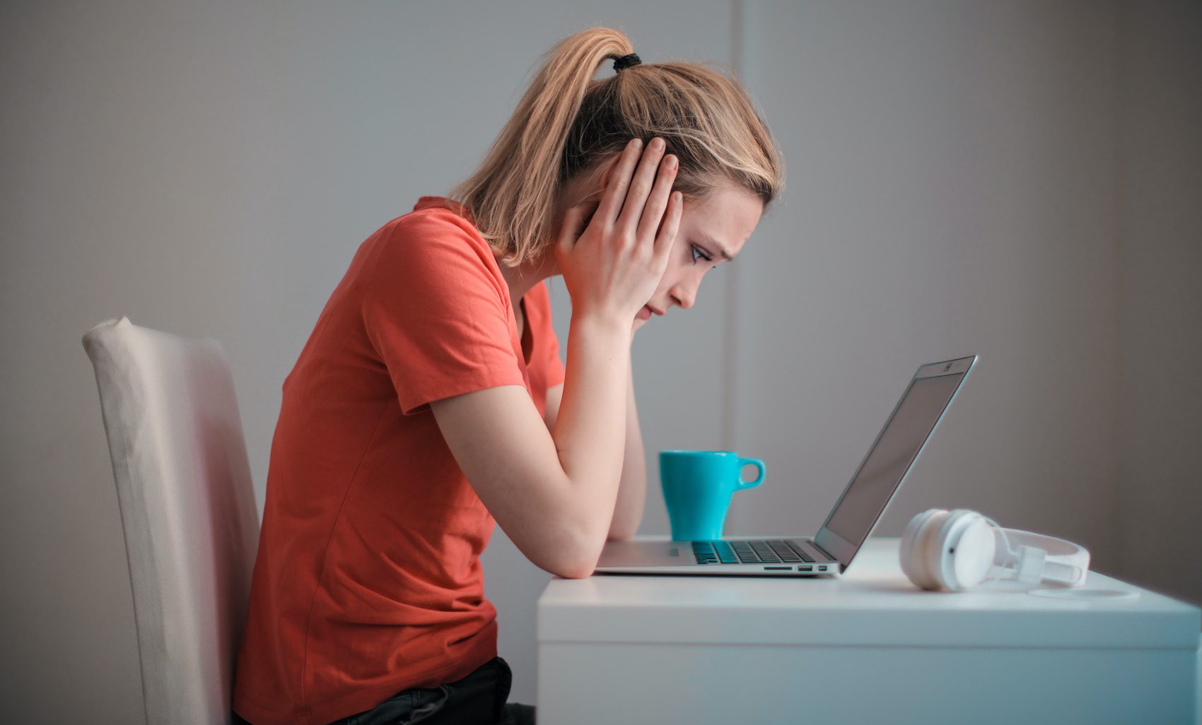 woman looking at laptop researching symptoms Somatoform Disorders and the Mind-Body Connection